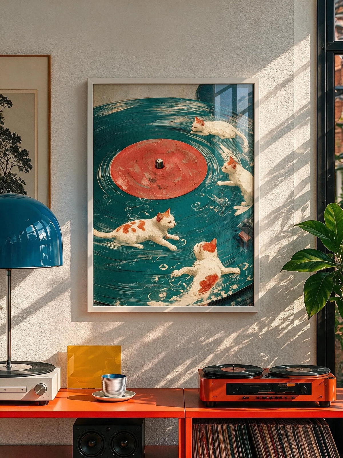 B-Side cats and vinyl record wall art in a pale frame, hung above a red console with a turntable and stacked vinyl.