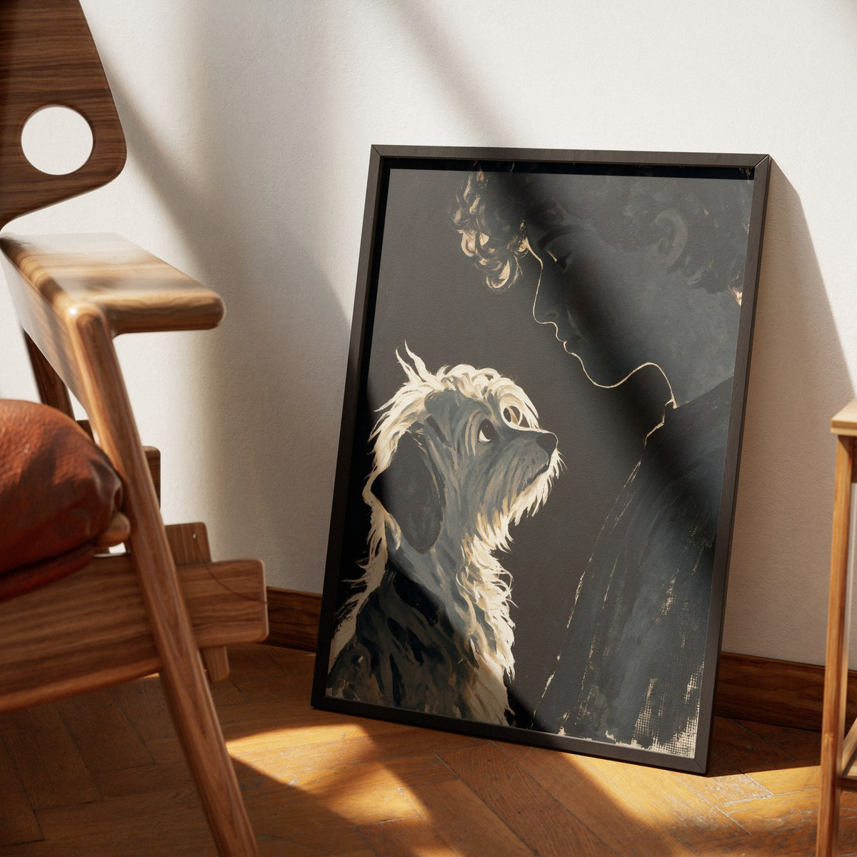 Devotion by Muse and Paw, a painterly print of a woman's profile in shadow with her terrier gazing up at her, framed and leaning against a wall in sunlight.