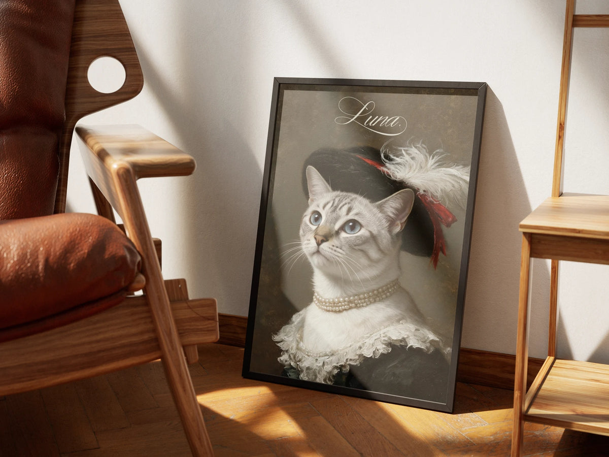 Feathered Hat by Muse and Paw, a Renaissance portrait of a pale tabby cat in a black plumed hat and pearls, framed and styled in a sunlit room with a leather armchair and wooden shelving.