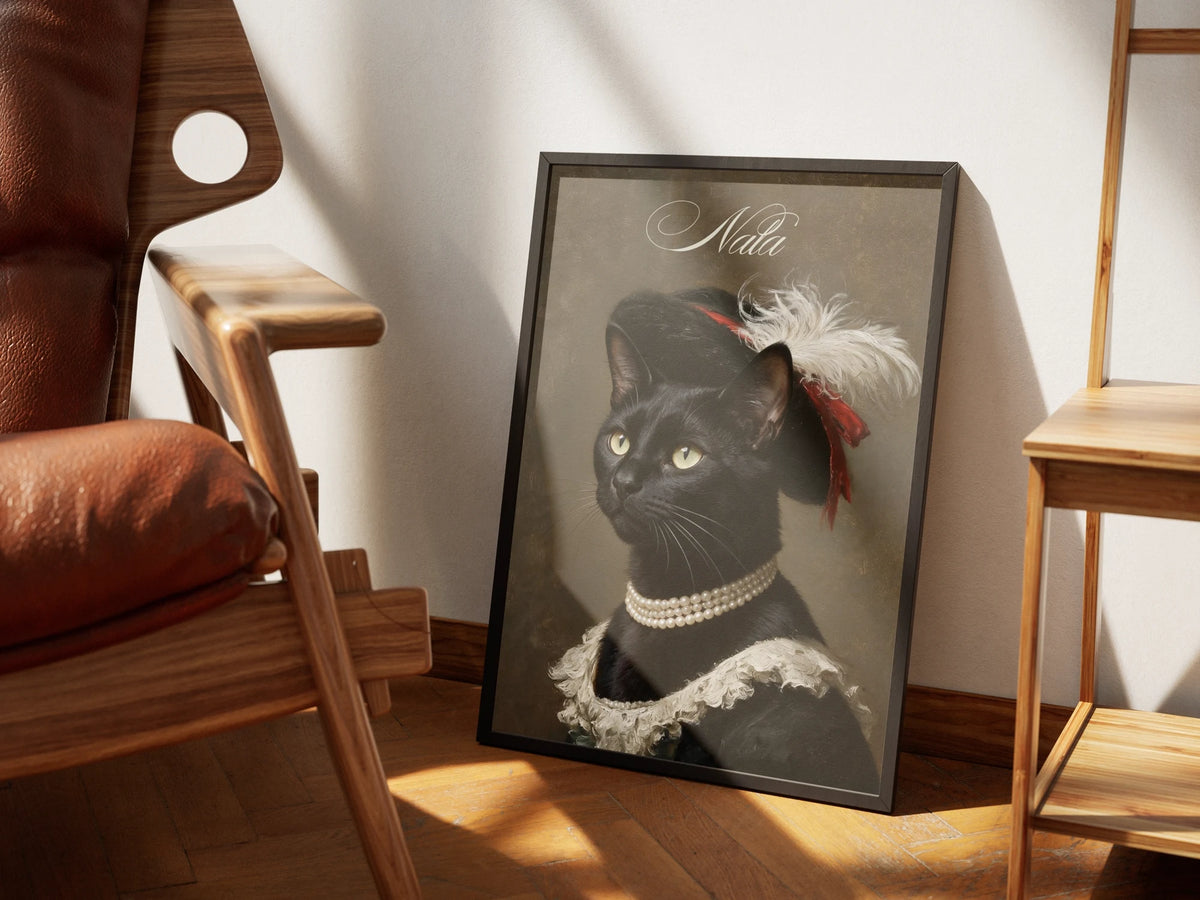 The same Feathered Hat painting by Muse and Paw with a black cat in the plumed hat, framed and styled in a sunlit room with a leather armchair and wooden shelving.
