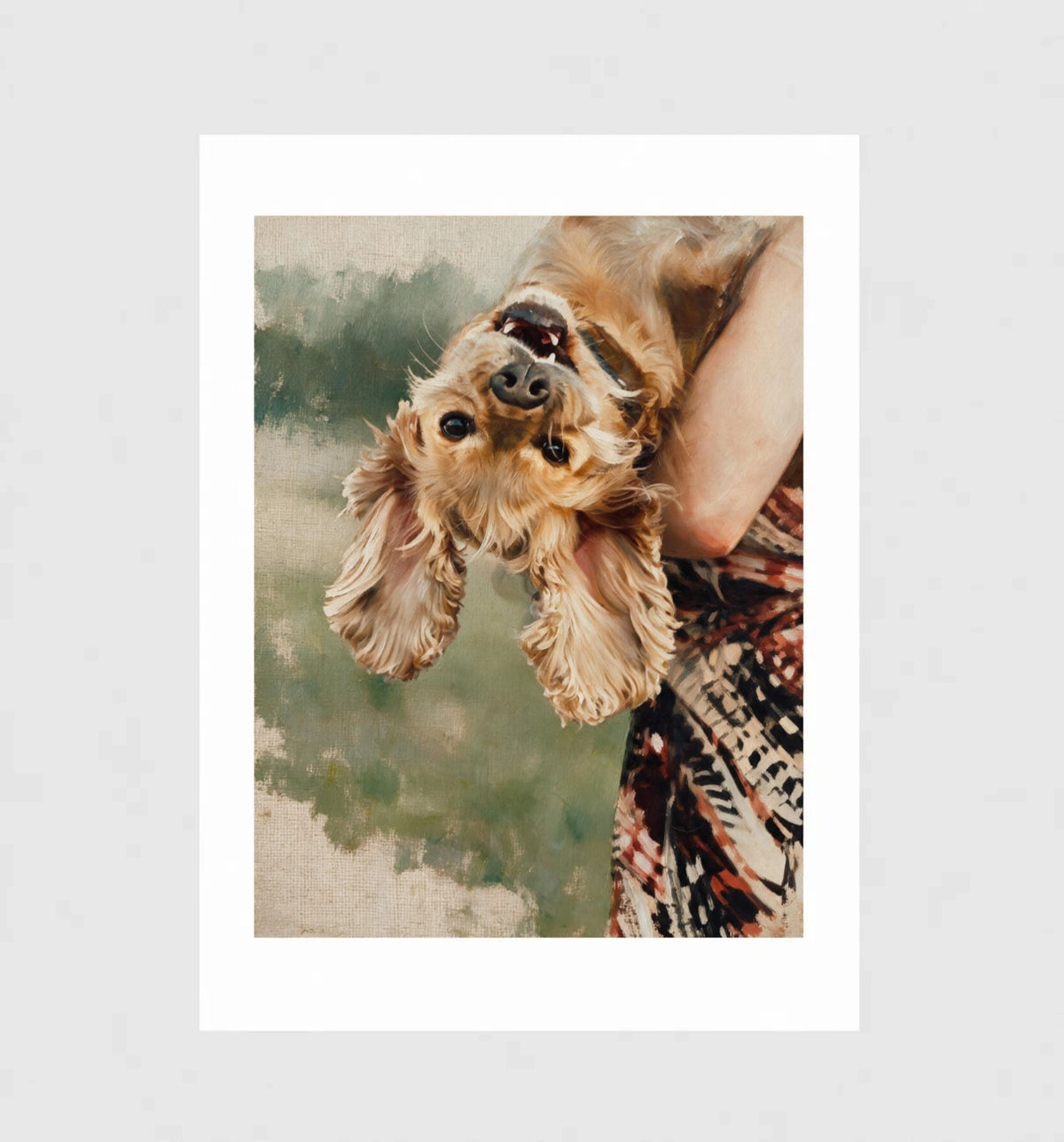 Flip by Muse and Paw, a painterly print of a cocker spaniel held upside down by its owner, framed and leaning against a wall.