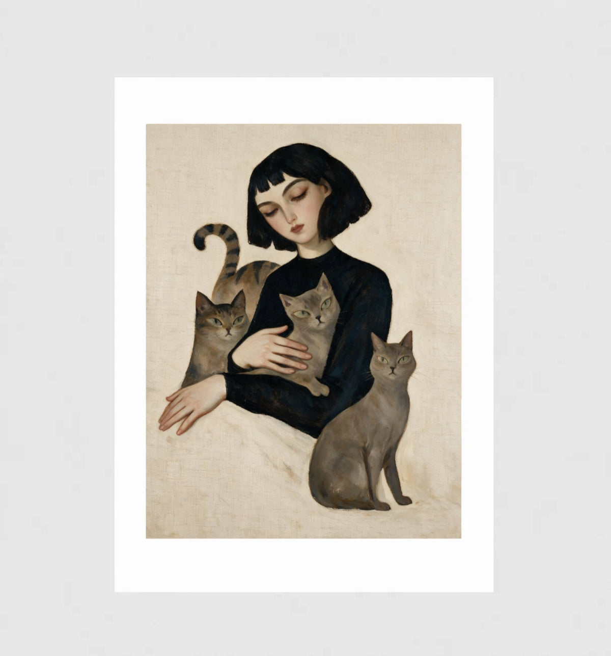Menagerie by Muse and Paw, a portrait print of a woman holding a tabby, a grey tabby, and a smoke-grey cat, framed and leaning against a wall.