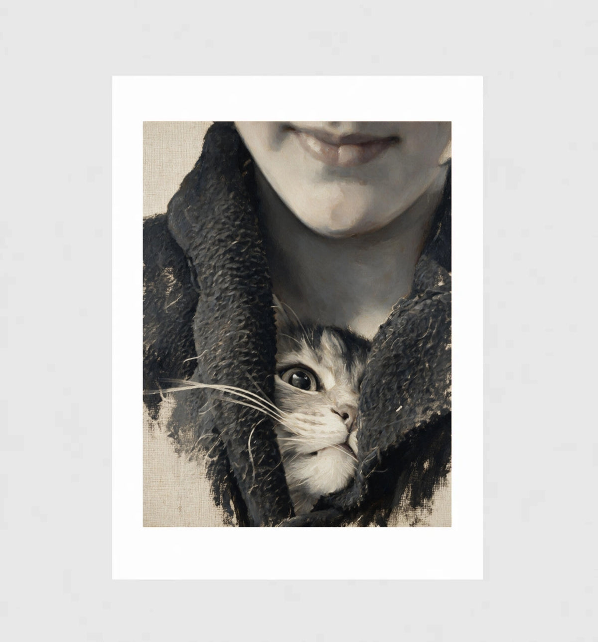 Stowaway by Muse and Paw, a close-up print of a kitten peeking out from a wool scarf, framed and leaning against a wall.